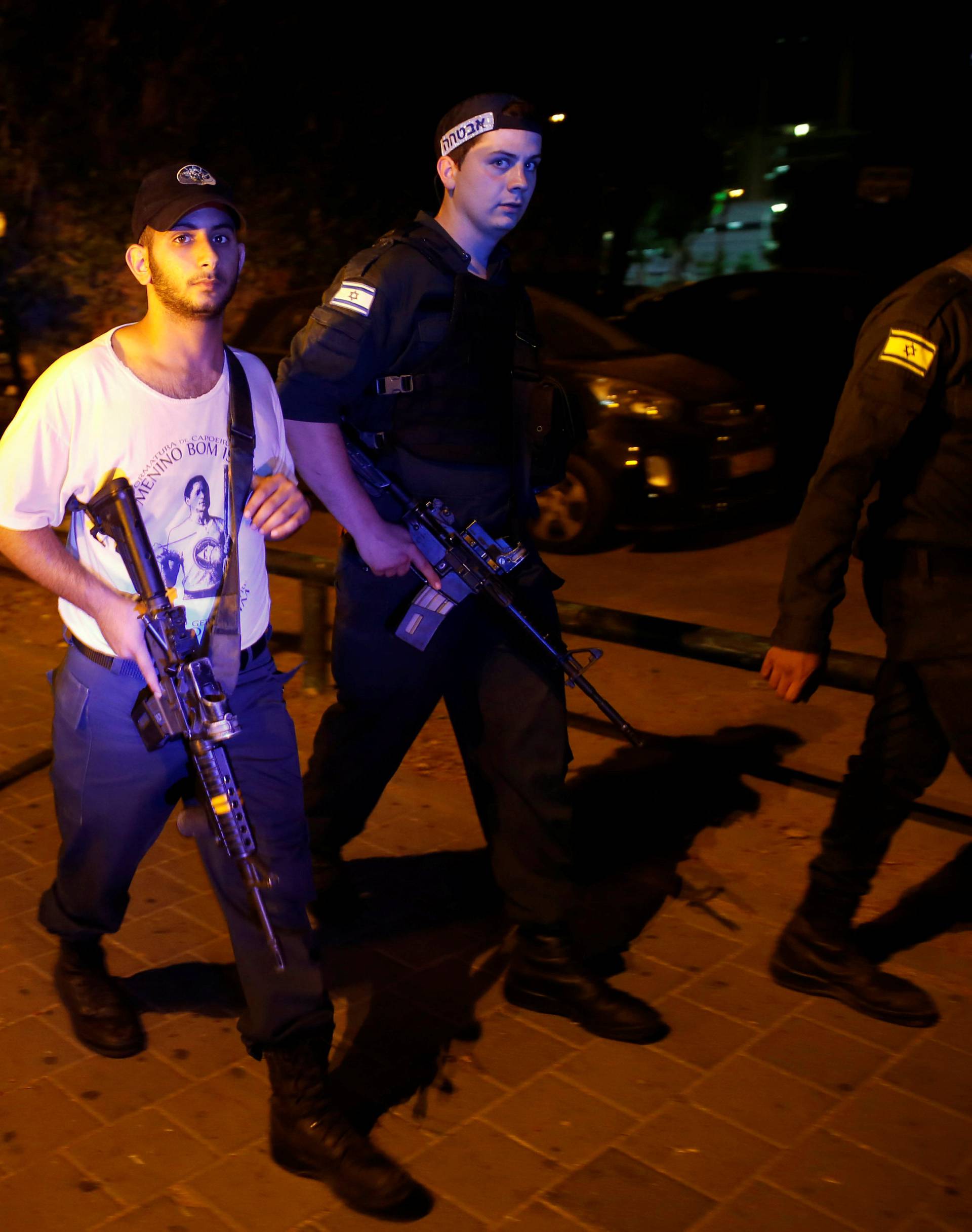 Israeli security personnel search the area following a shooting attack in the center of Tel Aviv