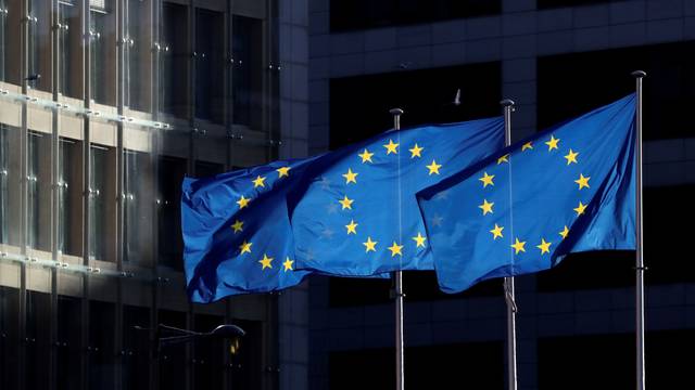 FILE PHOTO: European Union flags fly outside the European Commission headquarters in Brussels