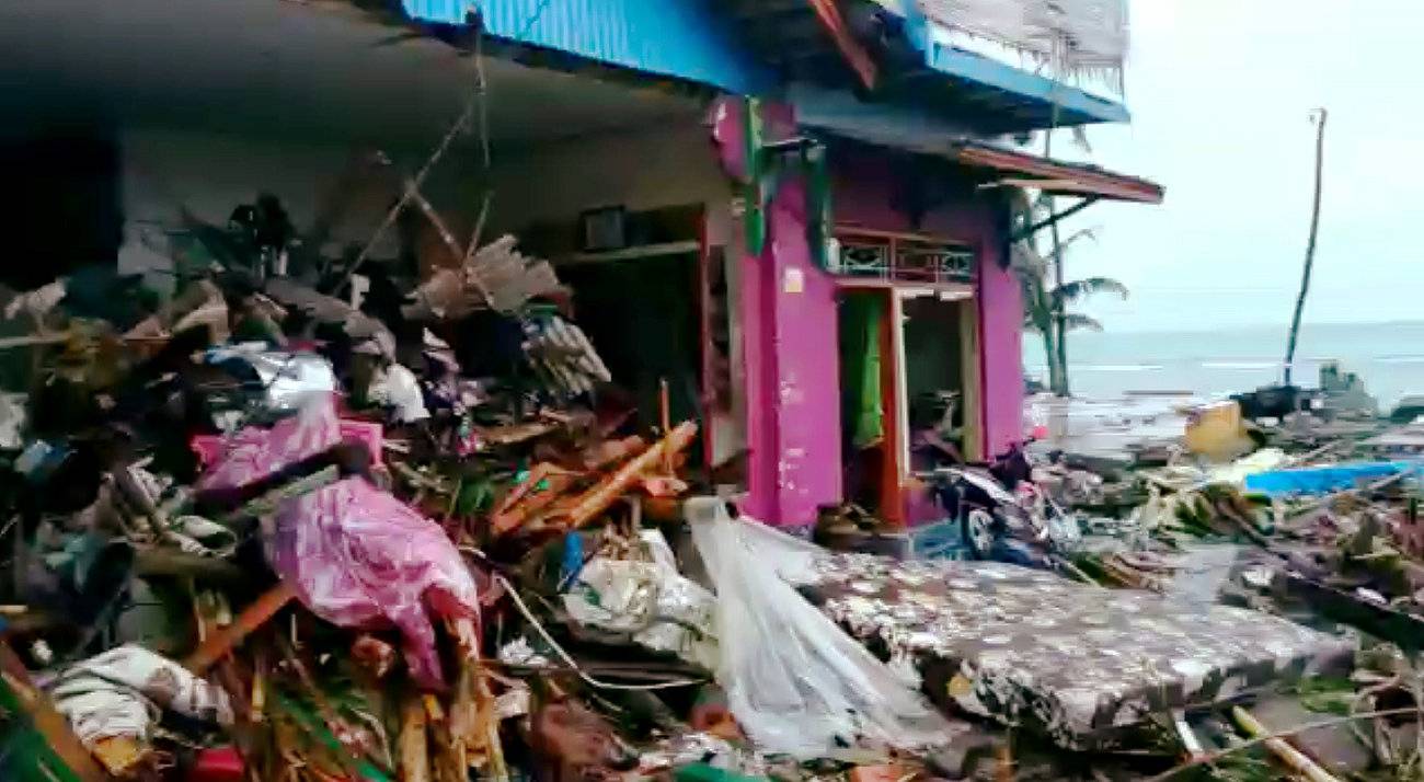 Debris surrounds a house damaged by tsunami at Lampung province