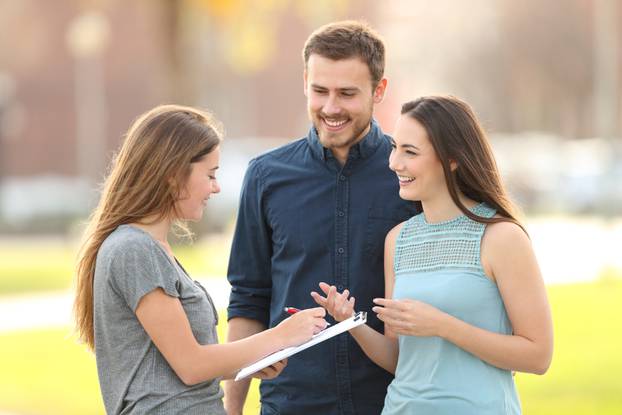 Happy,Couple,Asking,A,Survey,Standing,In,The,Street