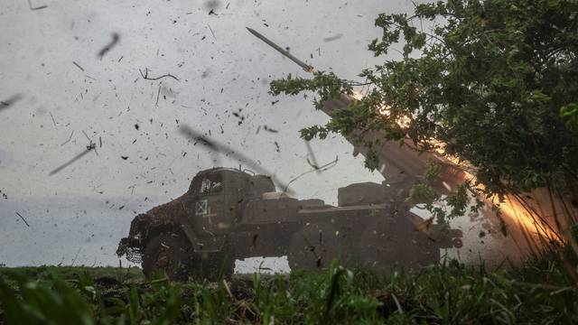 Ukrainian servicemen fire a BM-21 Grad multiple launch rocket system towards Russian troops in Donetsk region