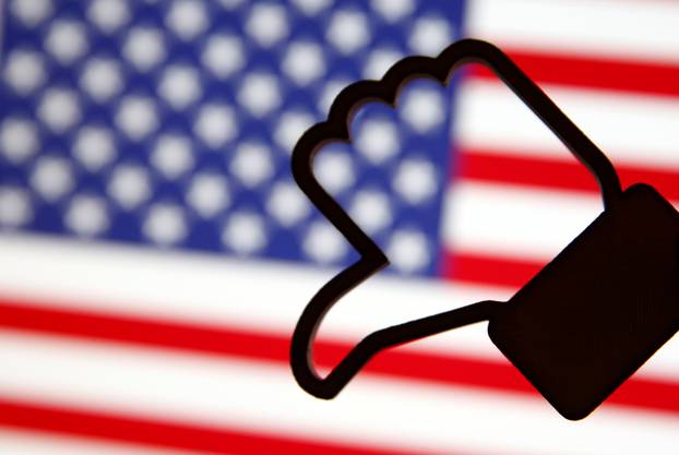 A 3D-printed Facebook Like symbol is displayed inverted in front of a U.S. flag in this illustration