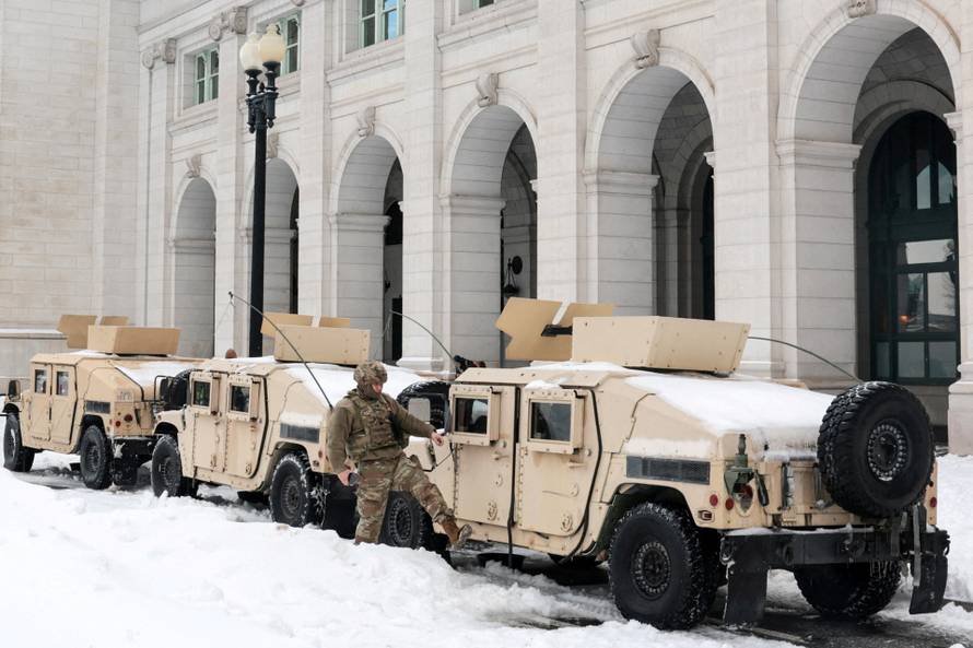 Commuters make their way though snow and ice in the aftermath of a winter storm in Washington