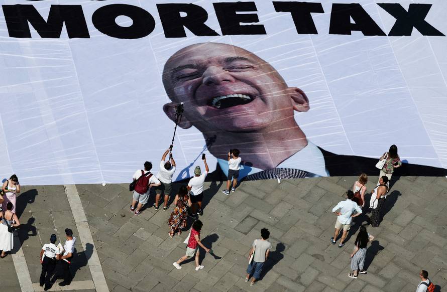A large banner against Amazon founder Jeff Bezos lies on the ground in St. Mark's Square