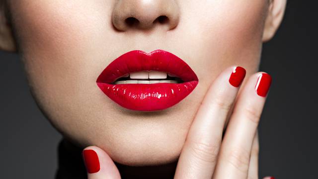 Closeup sexy female lips with red lipstick.