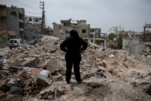 Displaced people cross the bridge linking southern Lebanon to the rest of the country