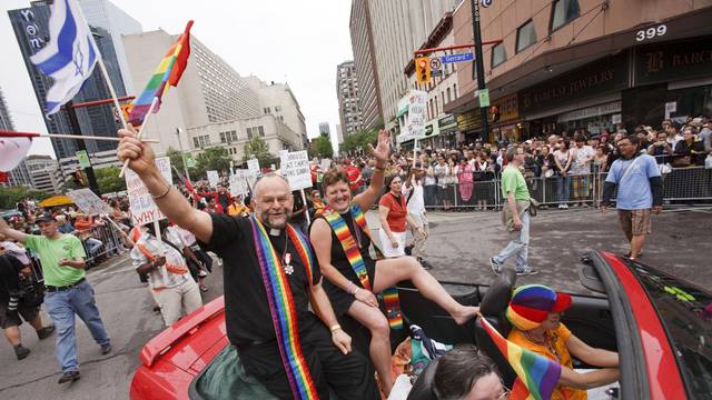 The Rev. Dr. Brent Hawkes & Rev. Jo Bell from the Metropolitan Community Church of Toronto ride down Yonge Street in the 29th Annual Pride Parade, Toronto, Canada.