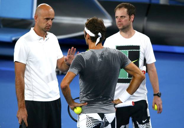 Switzerland's Roger Federer talks to his coaches Ivan Ljubicic and Severin Luthi during a training session ahead of the Australian Open tennis tournament in Melbourne