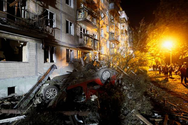 A damaged vehicle at the site of an apartment building hit by a Russian missile strike in Kyiv