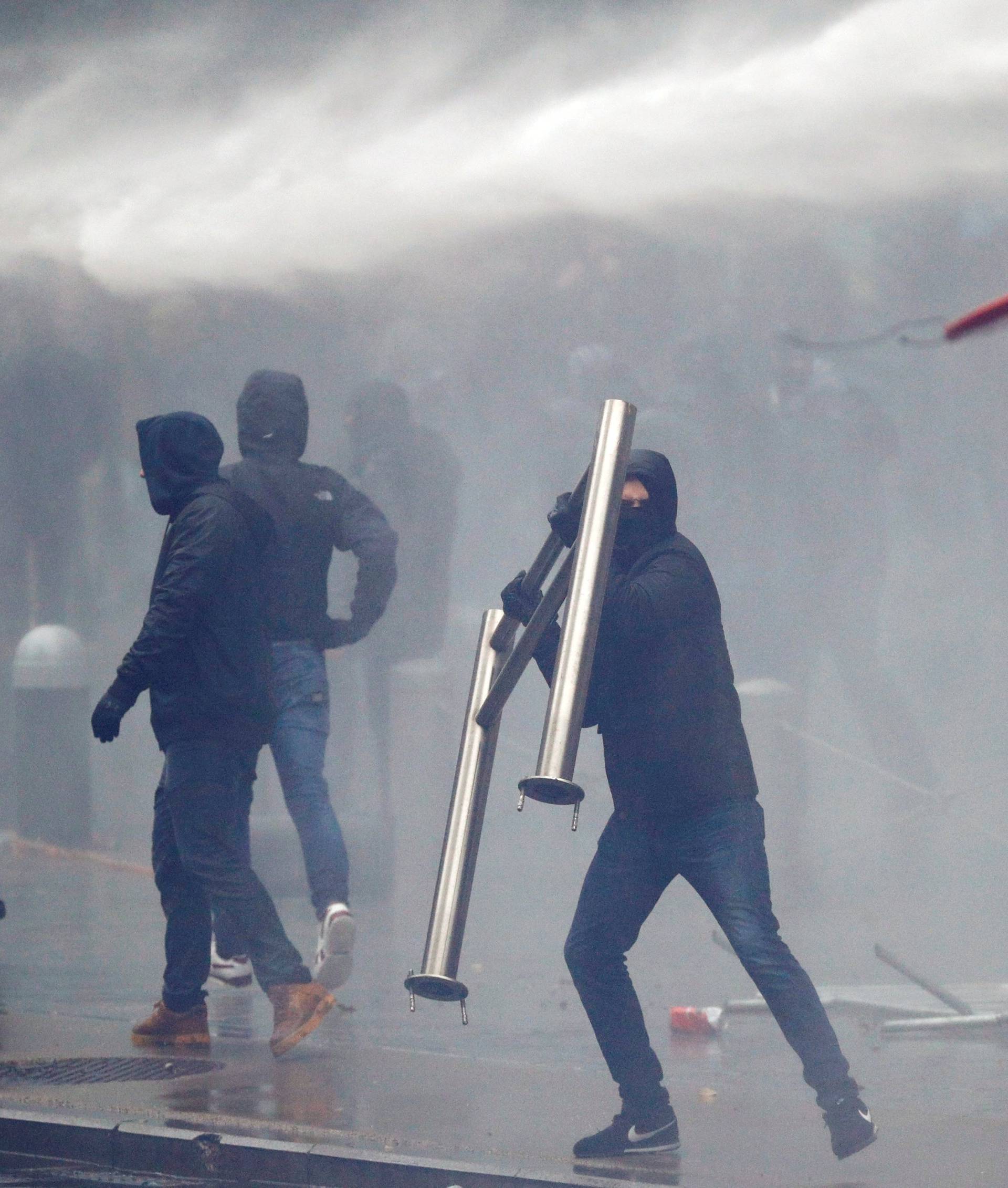 Far-right supporter throws a barricade during a protest against Marrakesh Migration Pact in Brussels