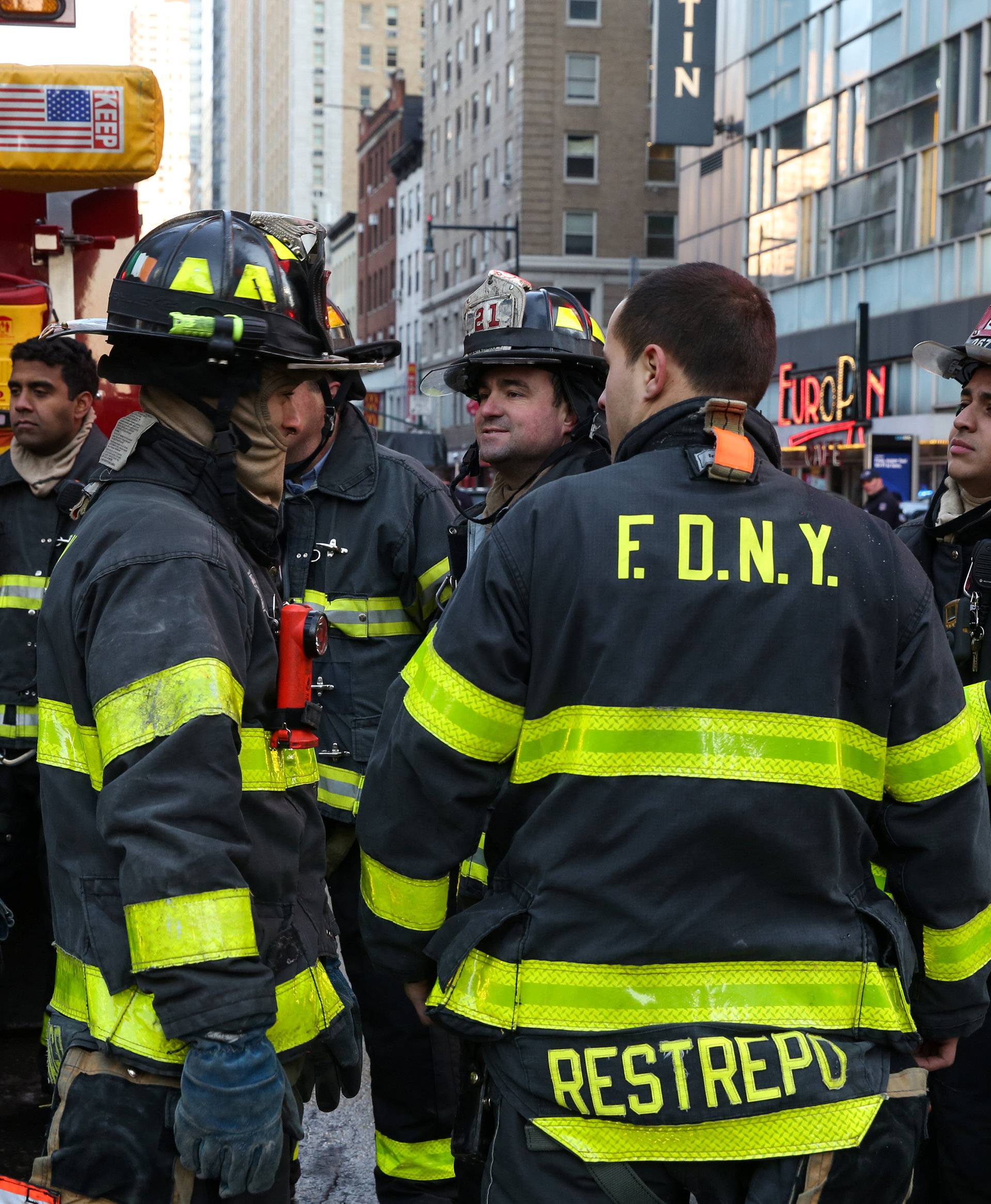 Fire Department of New York (FDNY) firefighters stand near Port Authority Bus Terminal after reports of an explosion in New York