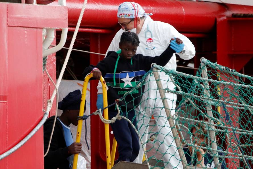 Migrants disembark at the port of Pozzallo after spending nearly two weeks on board the Medecins Sans Frontieres (MSF)-operated Ocean Viking