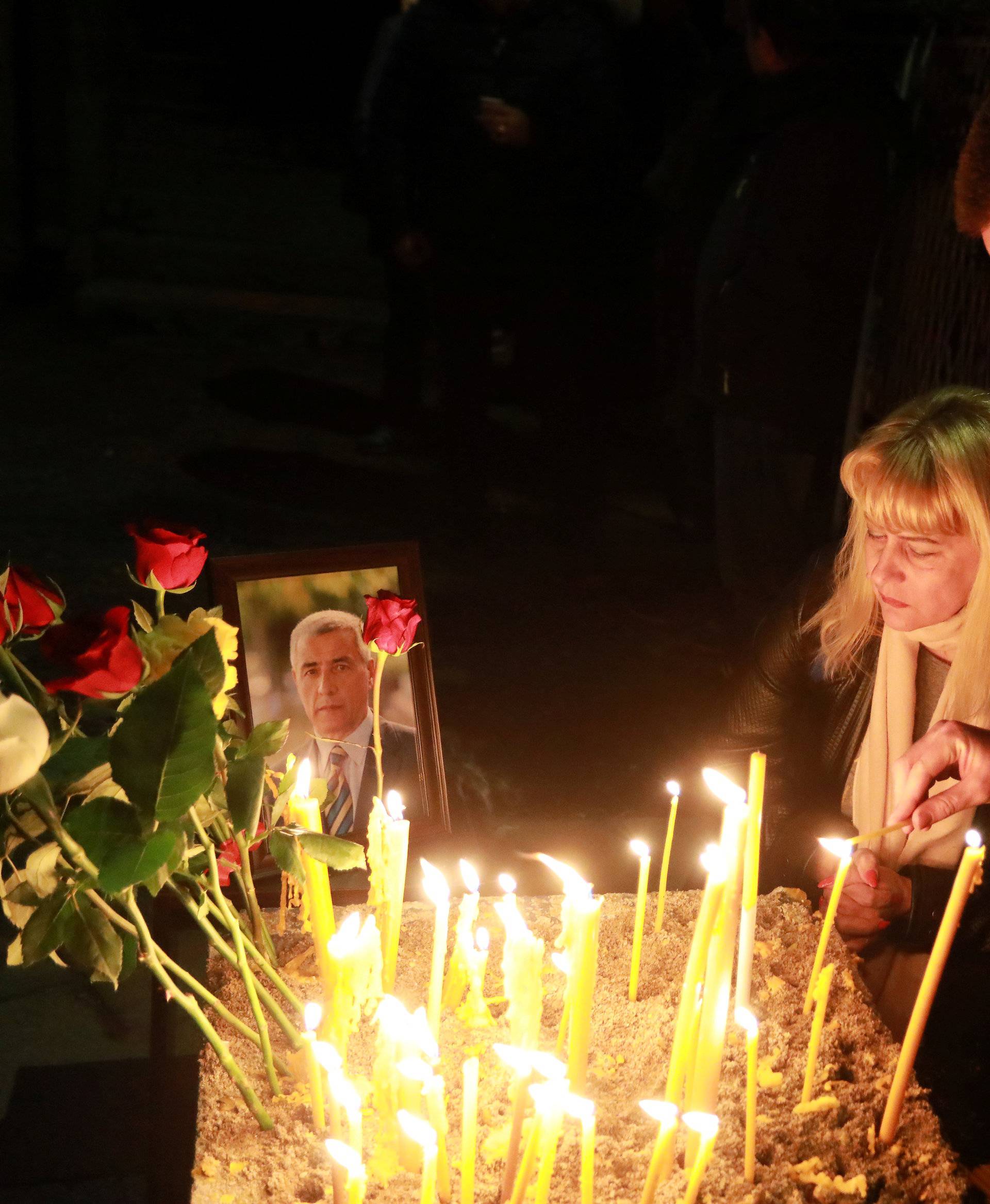 People gather to commemorate Kosovo Serb leader Oliver Ivanovic in front of his house in Kosovska Mitrovica