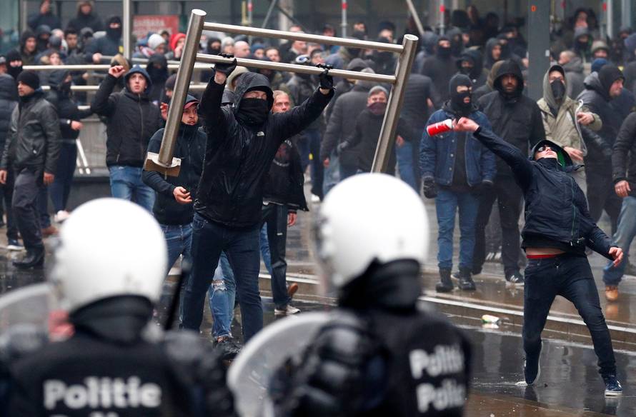 Far-right supporters throw barricades during a protest against Marrakesh Migration Pact in Brussels