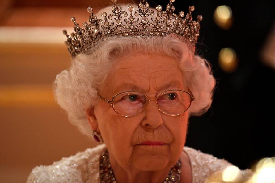 Britain's Queen Elizabeth listens during speeches at The Queen's Dinner during the Commonwealth Heads of Government Meeting at Buckingham Palace in London, Britain