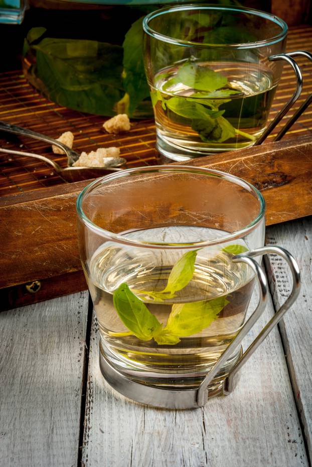 Basil herbal tea on wooden table