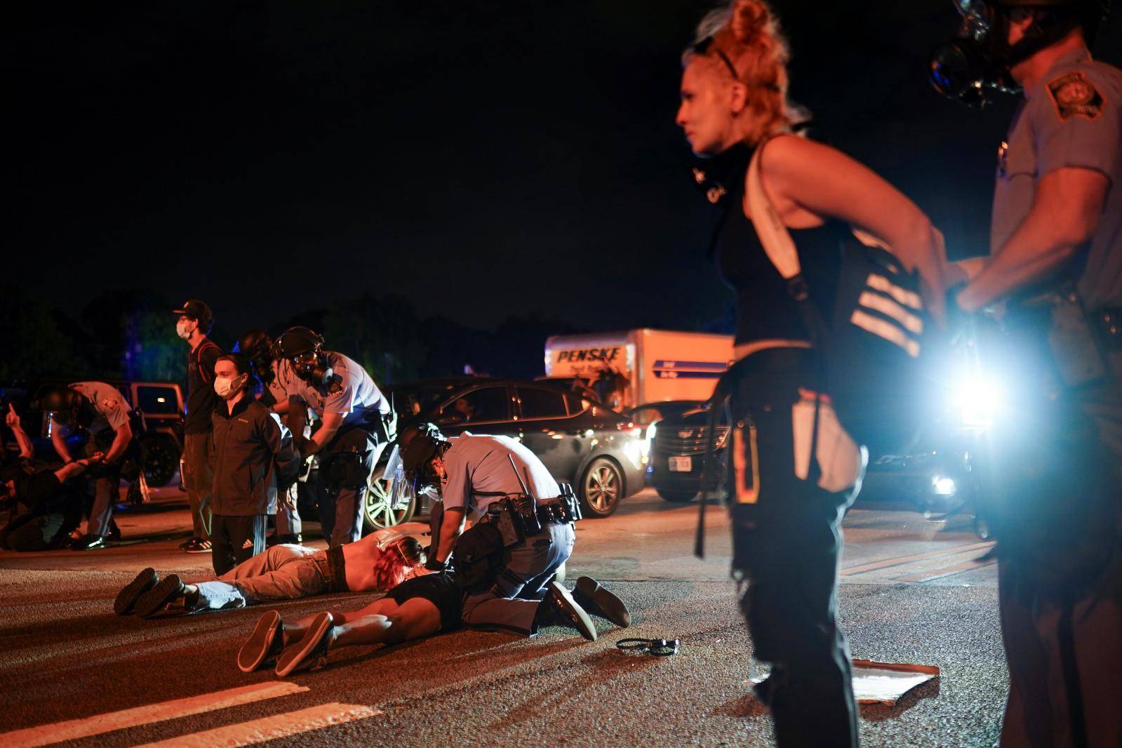 Police detain protesters for blocking traffic during a rally against racial inequality and the police shooting death of Rayshard Brooks, in Atlanta