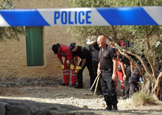 South Yorkshire police officers and members of the Greek rescue service (in red uniforms) investigate the ground before commencing excavating a site for Ben Needham, a 21 month old British toddler who went missing in 1991, on the island of Kos