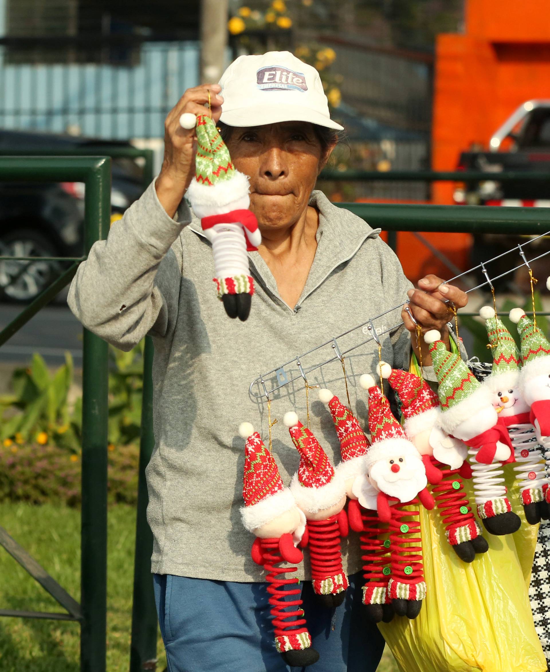 A woman sells Christmas decoration at a traffic junction in Lima