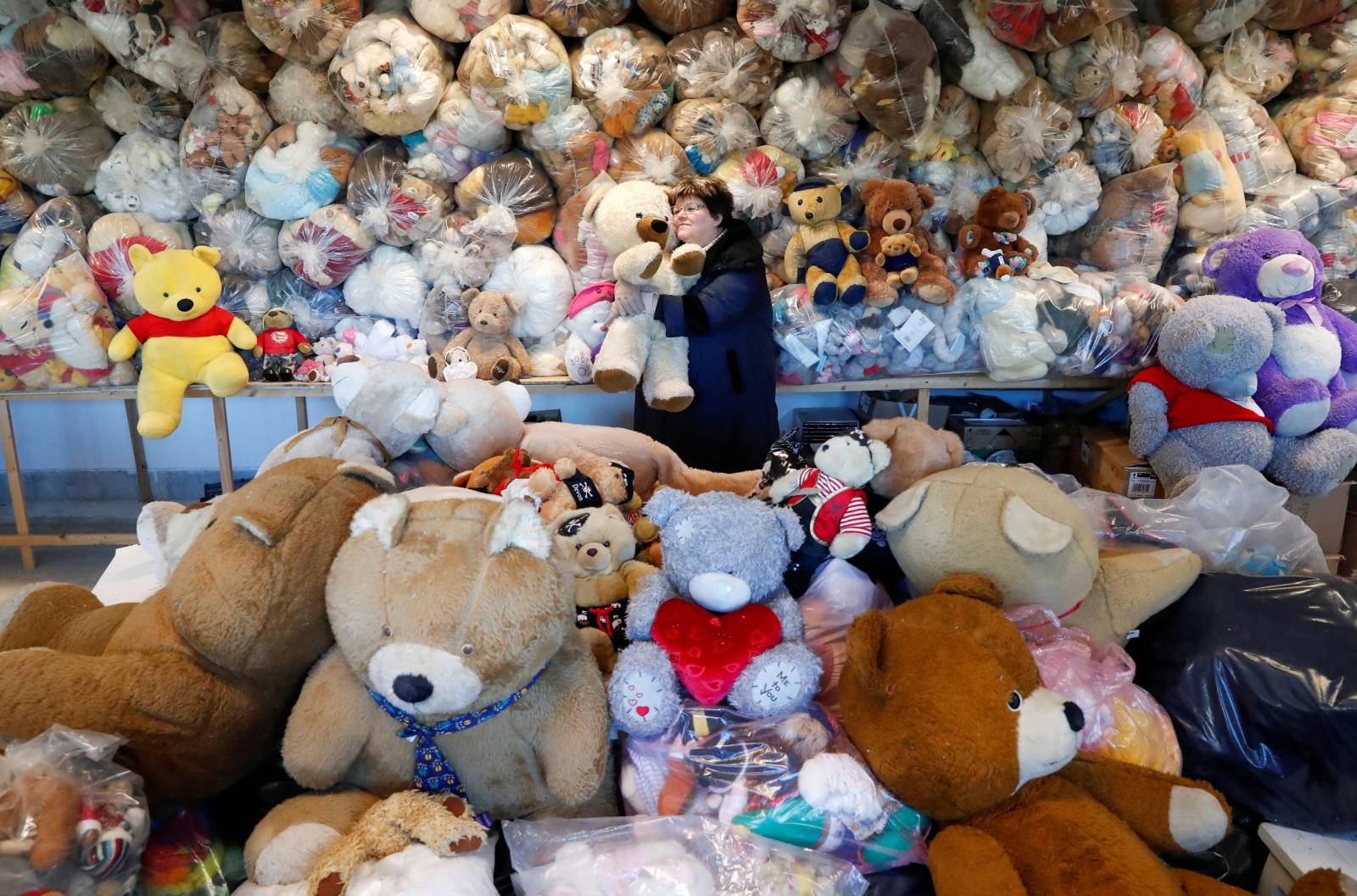 Valeria Schmidt, nicknamed as "Teddy Bear Mama", hugs a teddy bear in Harsany