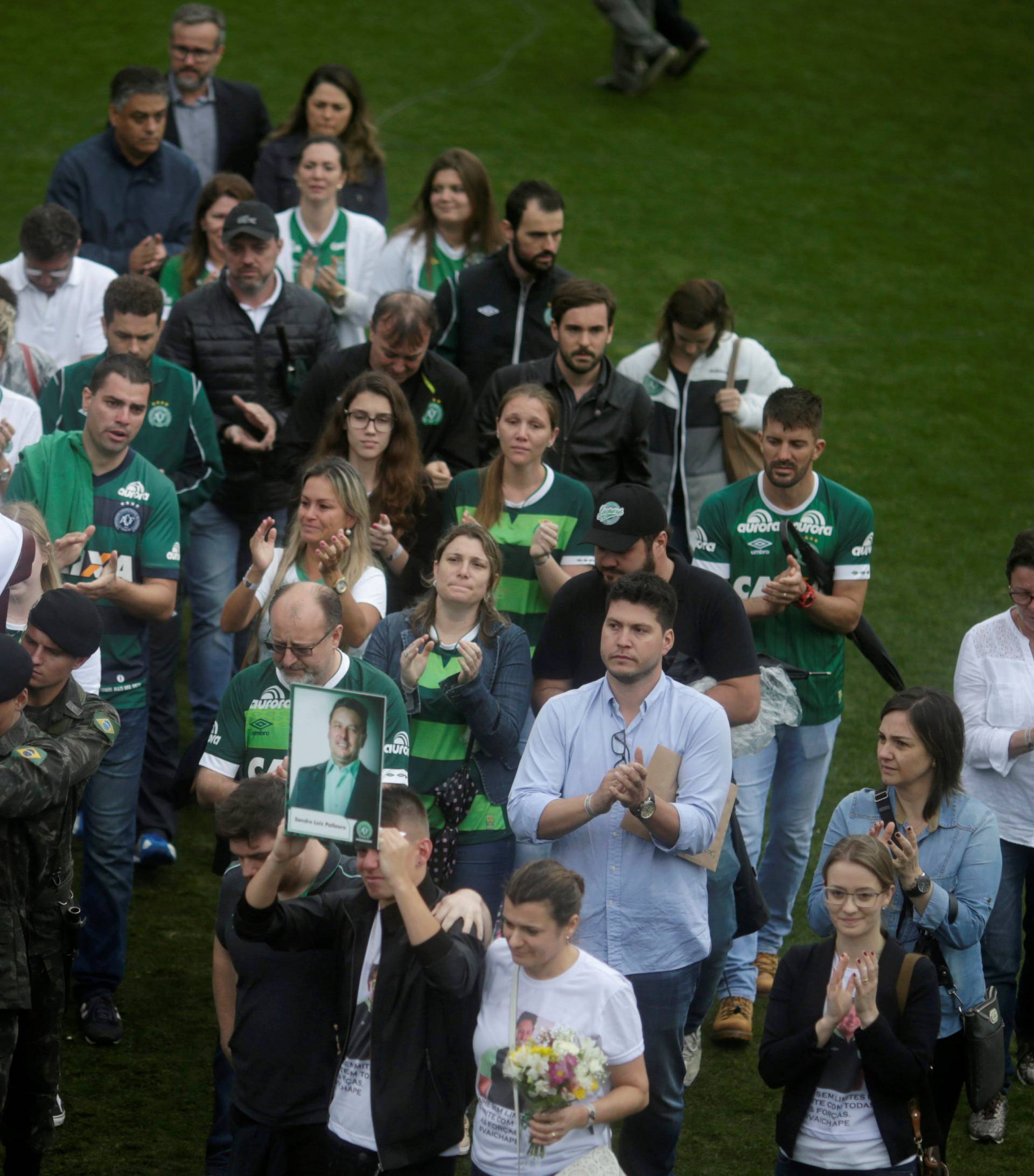 Relatives of the victims of the plane crash in Colombia participate in a ceremony to pay tribute to them at Arena Conda stadium in Chapeco