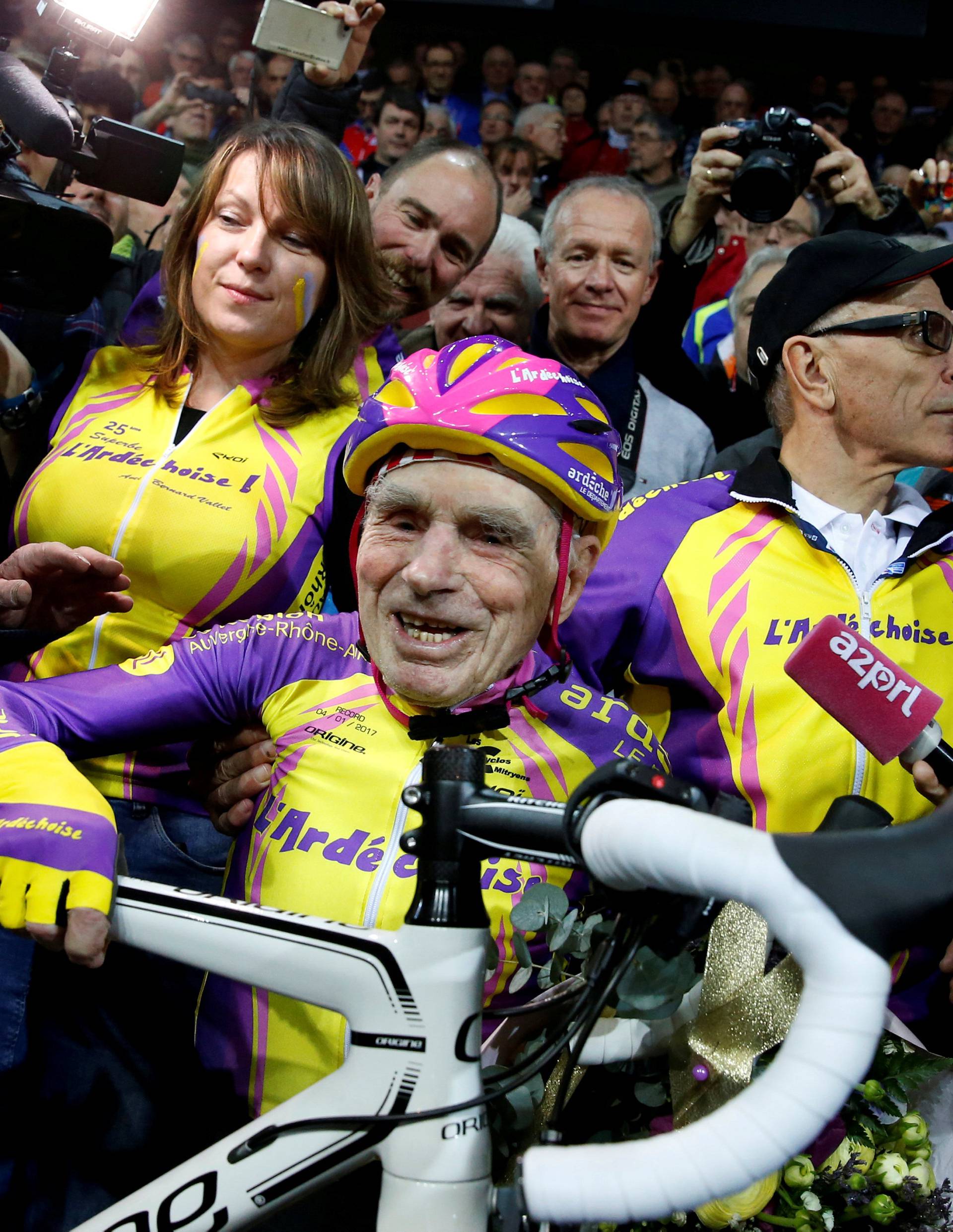 FILE PHOTO: French cyclist Robert Marchand, aged 105, reacts after he rode 22.528 km (14.08 miles) in one hour to set a new record at the indoor Velodrome National in Montigny-les-Bretonneux