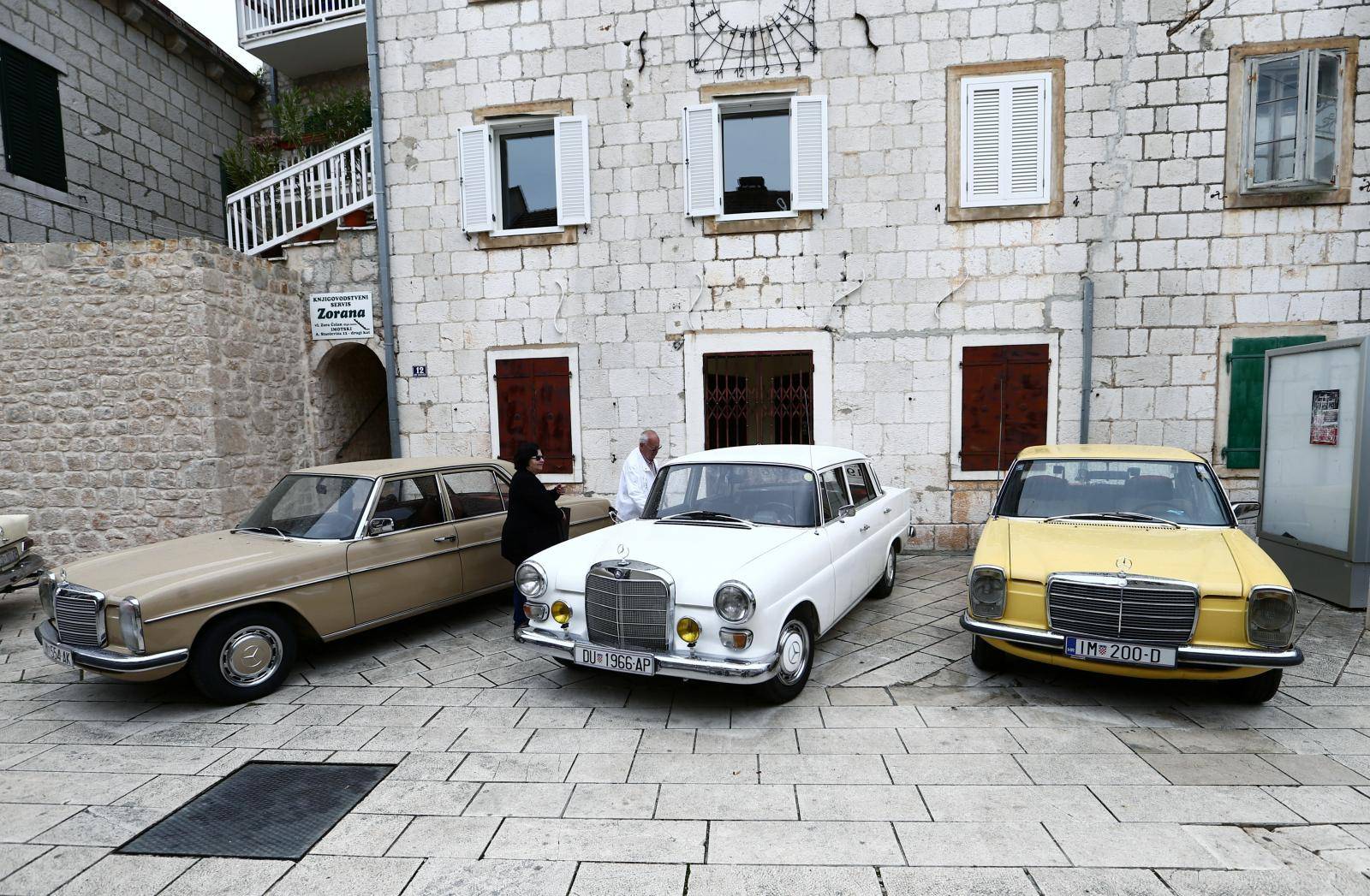 People get into an old-timer Mercedes car in Imotski