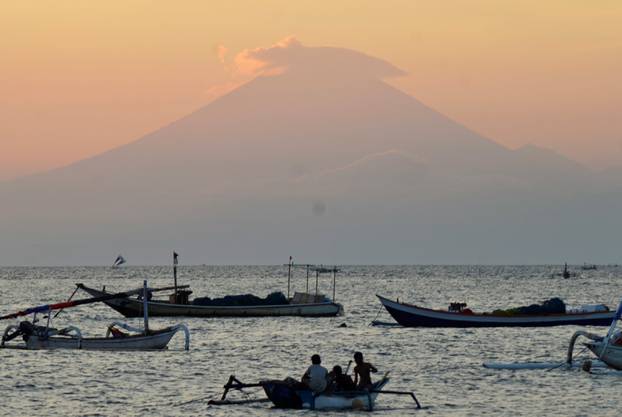 Mount Agung, an active volcano located on the resort island of Bali that has been placed on alert level 3 following recent seismic activity, is seen from Mataram on nearby Lombok island