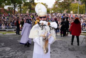 People attend the Tompkins Square Park Halloween Dog Parade at East River Park in the Manhattan borough of New York City