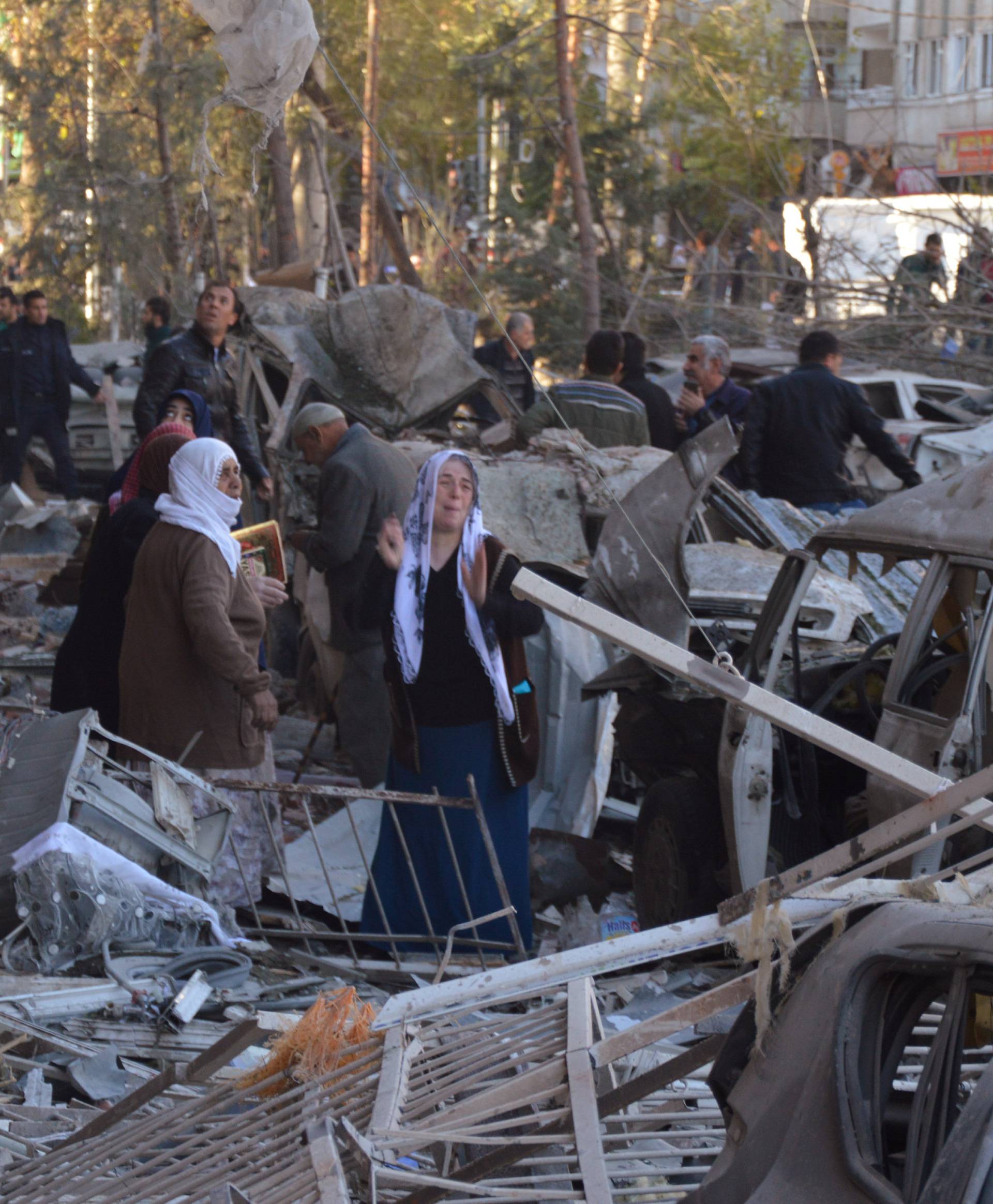 Residents react after a blast in Diyarbakir