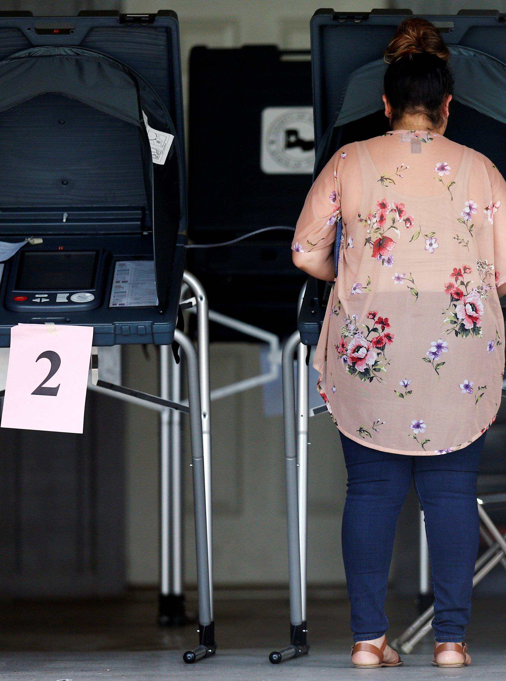 A woman votes at a polling station during the midterm elections in Houston