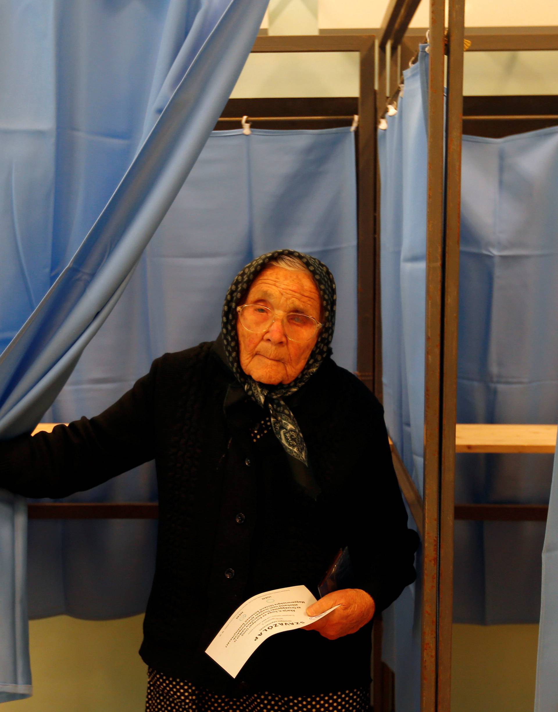 A Hungarian woman votes in a referendum on the European Union's migrant quotas in village of Roszke near the Serbian border