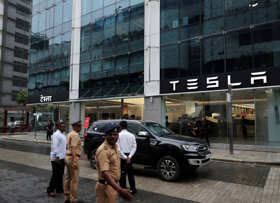 FILE PHOTO: Police direct traffic outside the Tesla showroom ahead of its opening in Mumbai