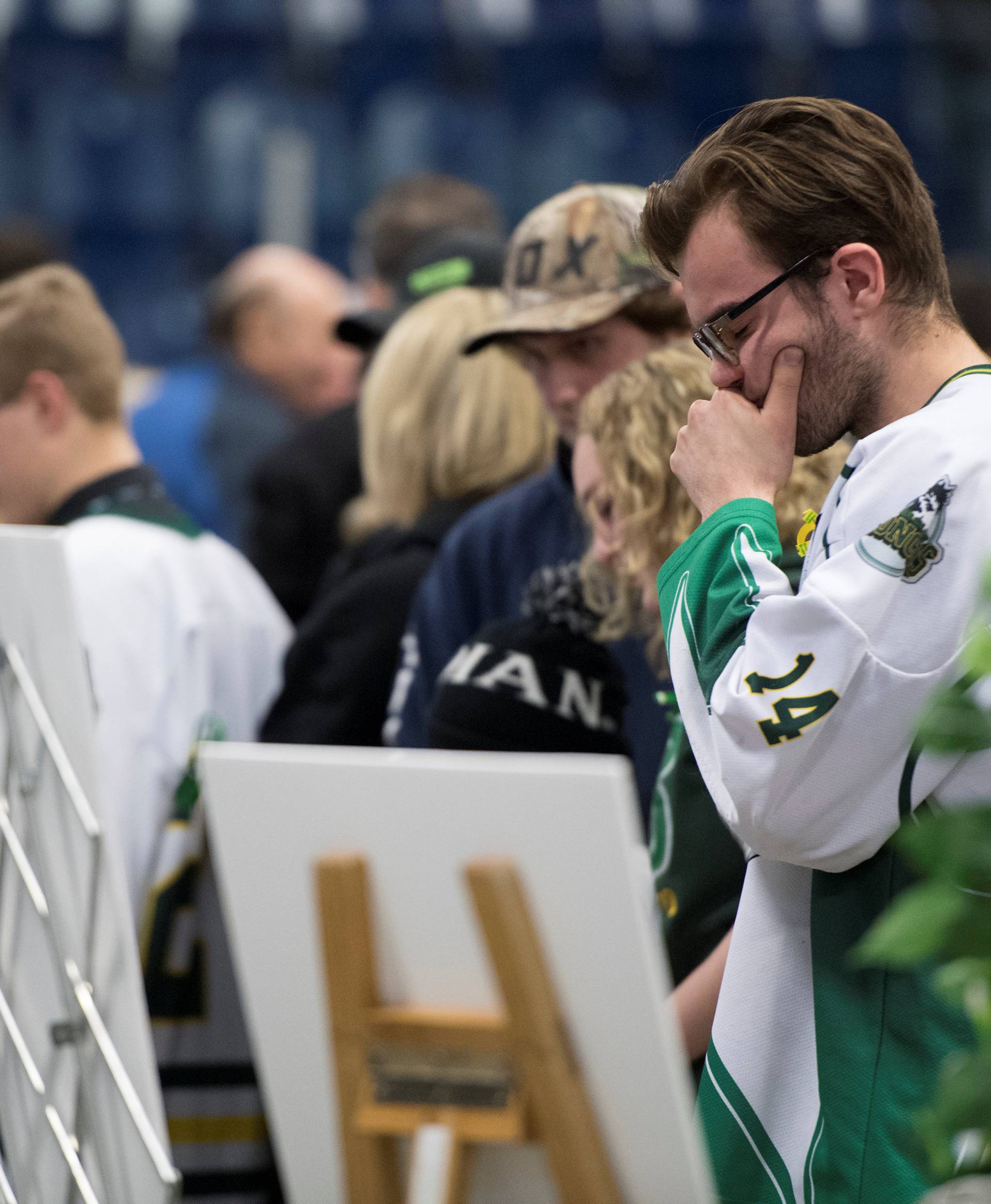 Mourners attend a vigil at the Elgar Petersen Arena, home of the Humboldt Broncos, to honour the victims of a fatal bus accident in Humboldt