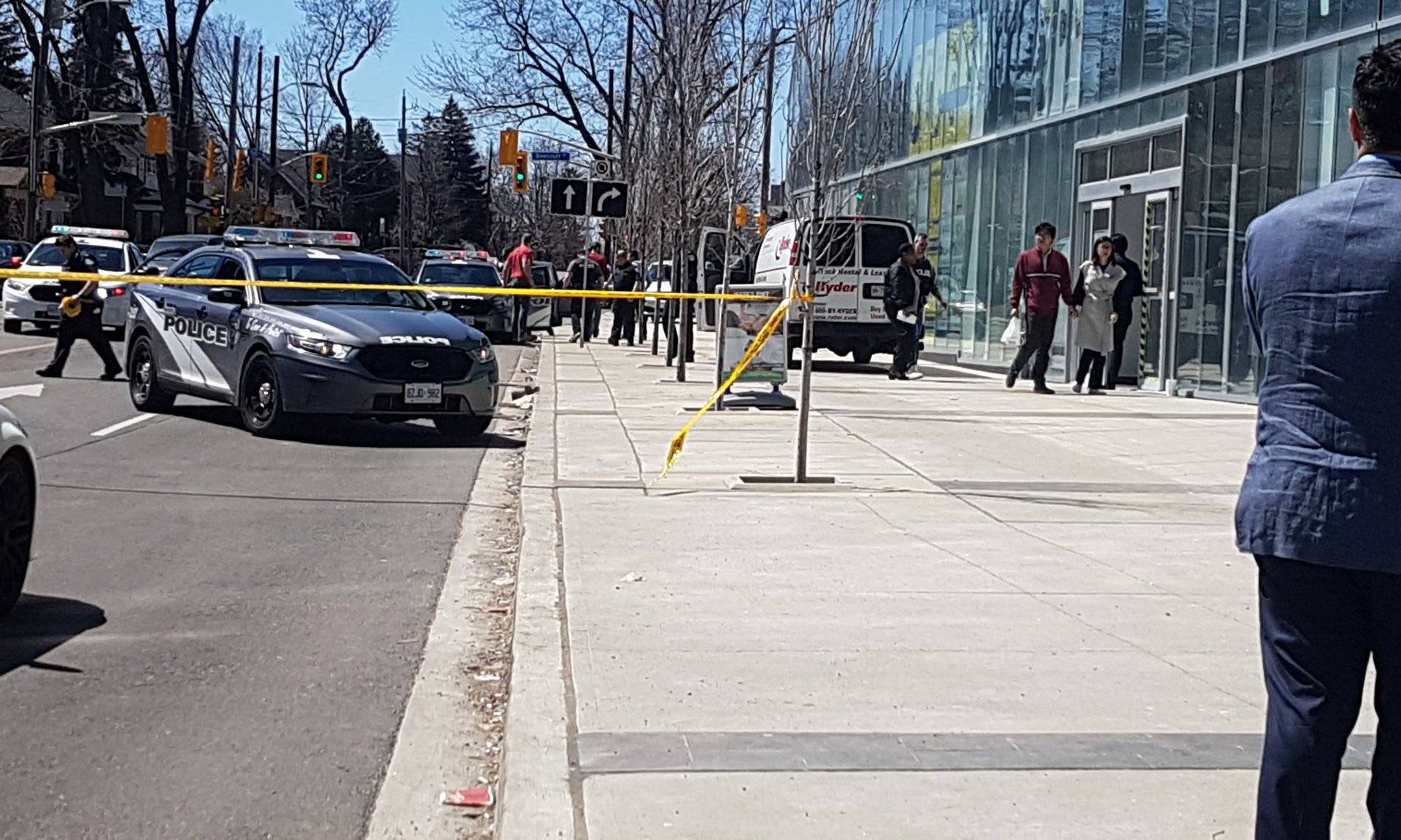 Police officers arrest suspect driver after a van hit multiple people at a major intersection in Toronto