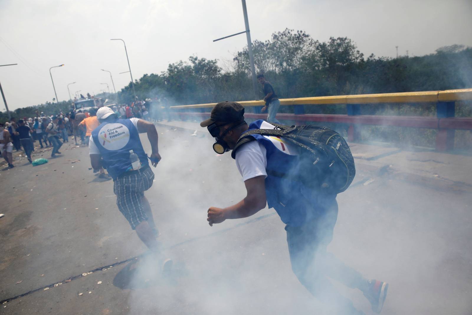 Demonstrators clash with Venezuela's security forces at the Francisco de Paula Santander bridge on the border line between Colombia and Venezuela as seen from Cucuta