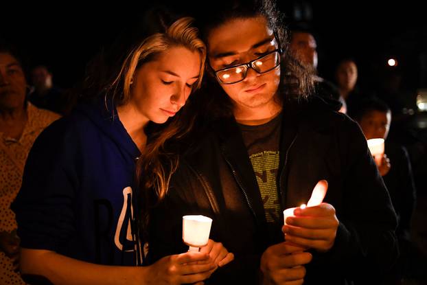 Local residents take part in a vigil for victims of a mass shooting in Sutherland Springs, Texas