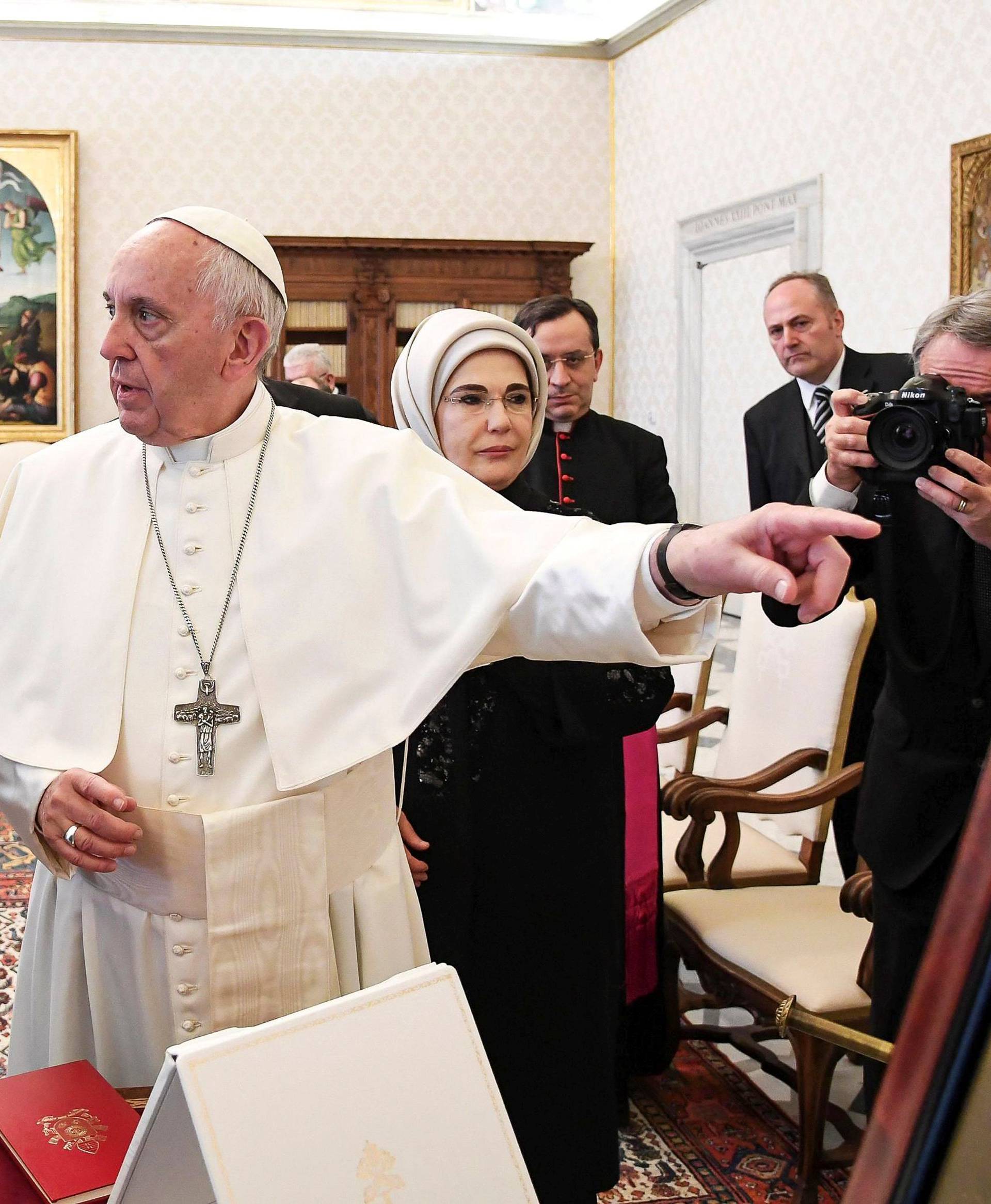 Pope Francis exchanges gift with Turkish President Tayyip Erdogan and his wife Emine during a private audience at the Vatican