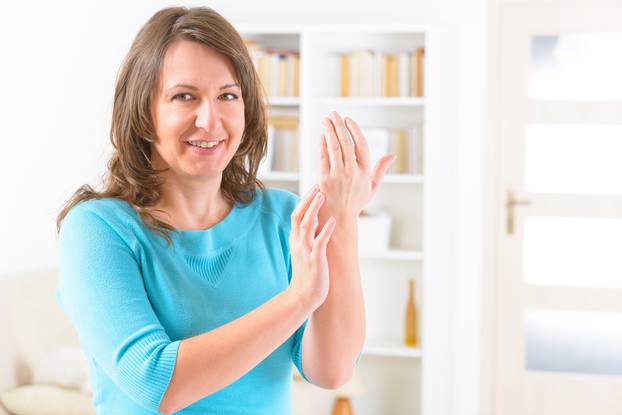 Woman doing EFT on the karate chop point. Emotional Freedom Tech