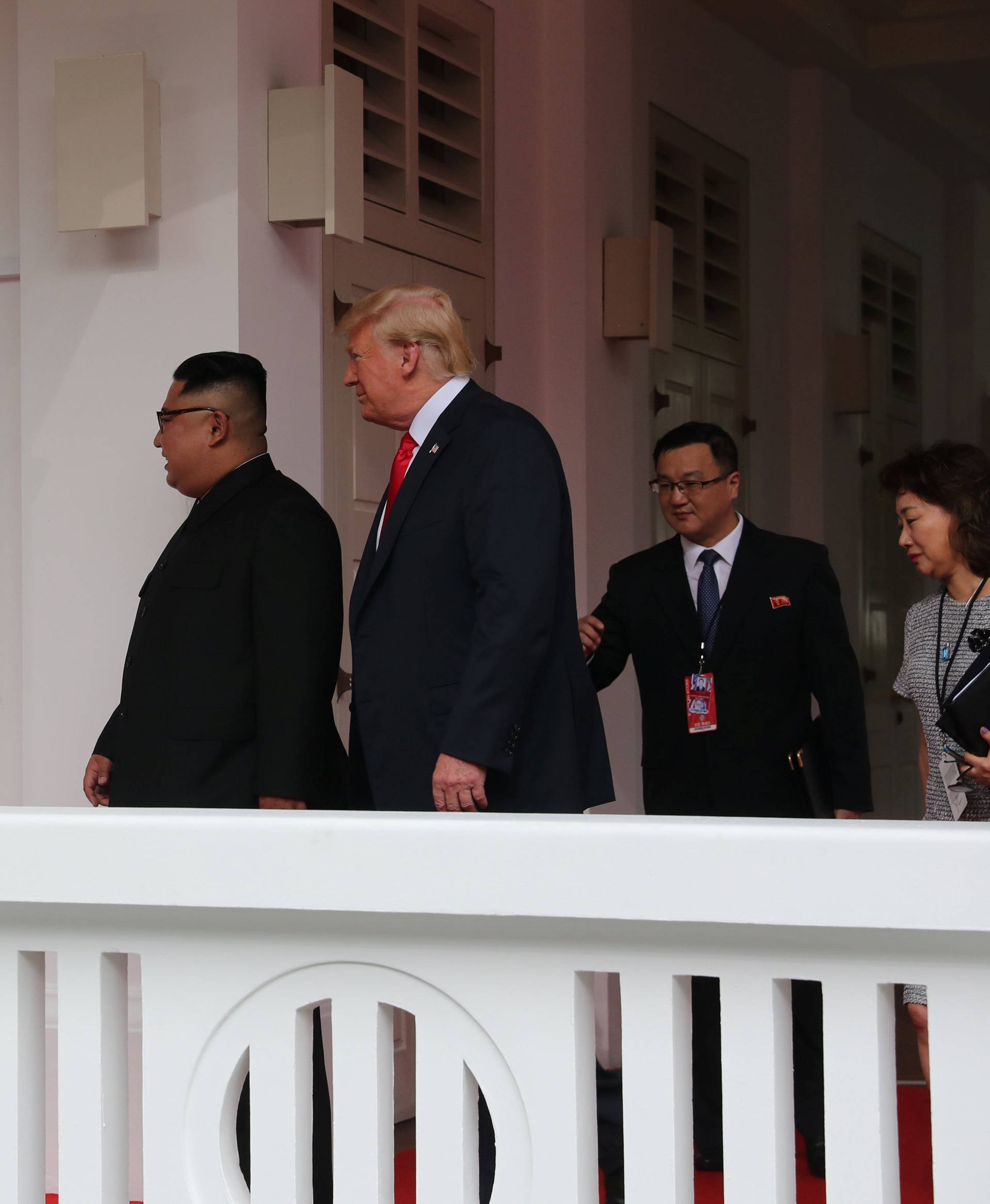 U.S. President Donald Trump walks with North Korean leader Kim Jong Un at the Capella Hotel on Sentosa island in Singapore