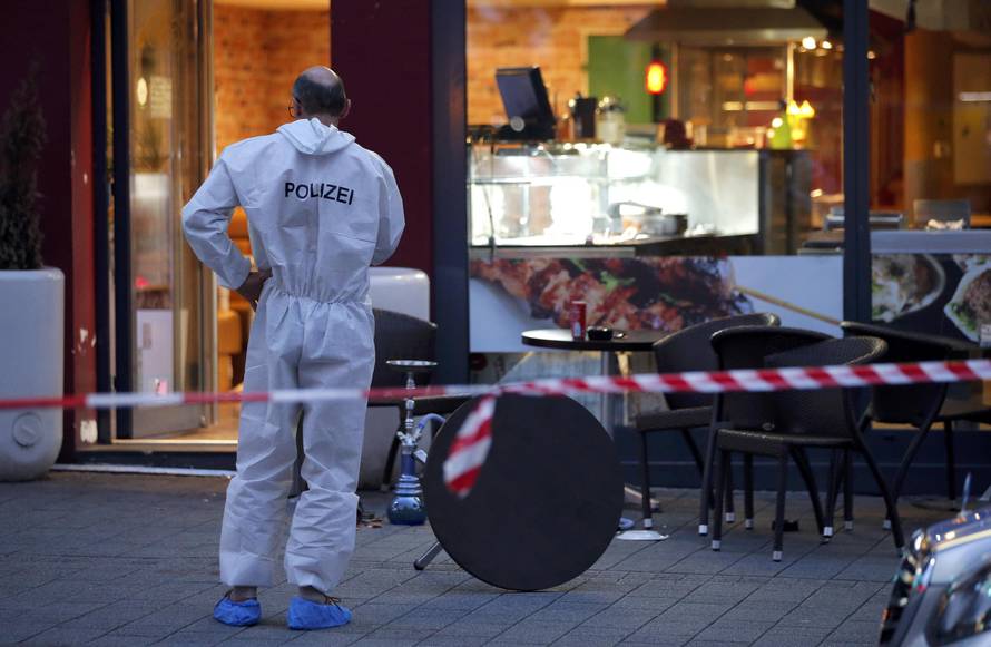A police forensic expert works outside where a 21-year-old Syrian refugee killed a woman with a machete in Reutlingen