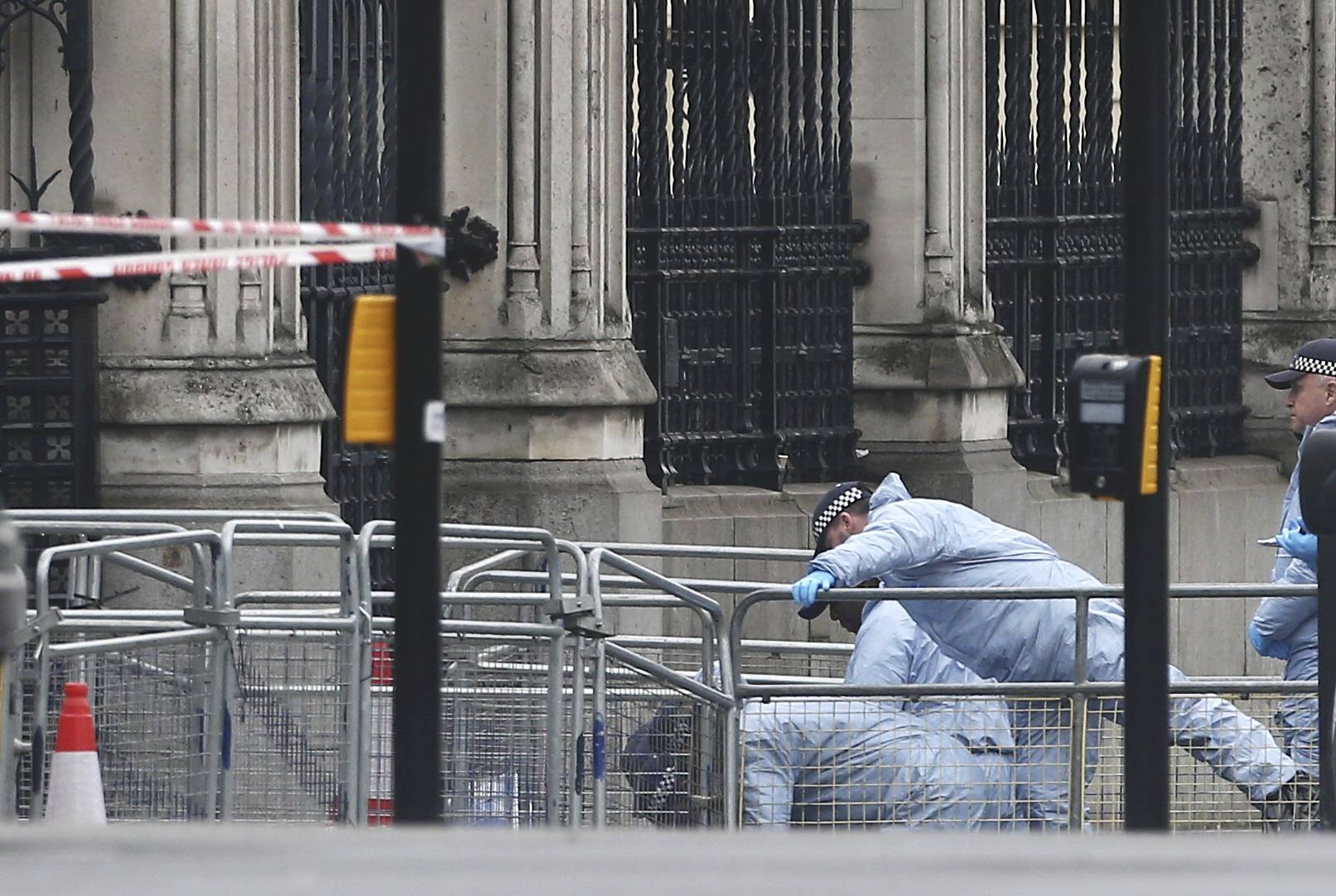 Police work at Carriage Gate outside the Houses of Parliament the morning after an attack by a man driving a car and weilding a knife left five people dead and dozens injured, in London