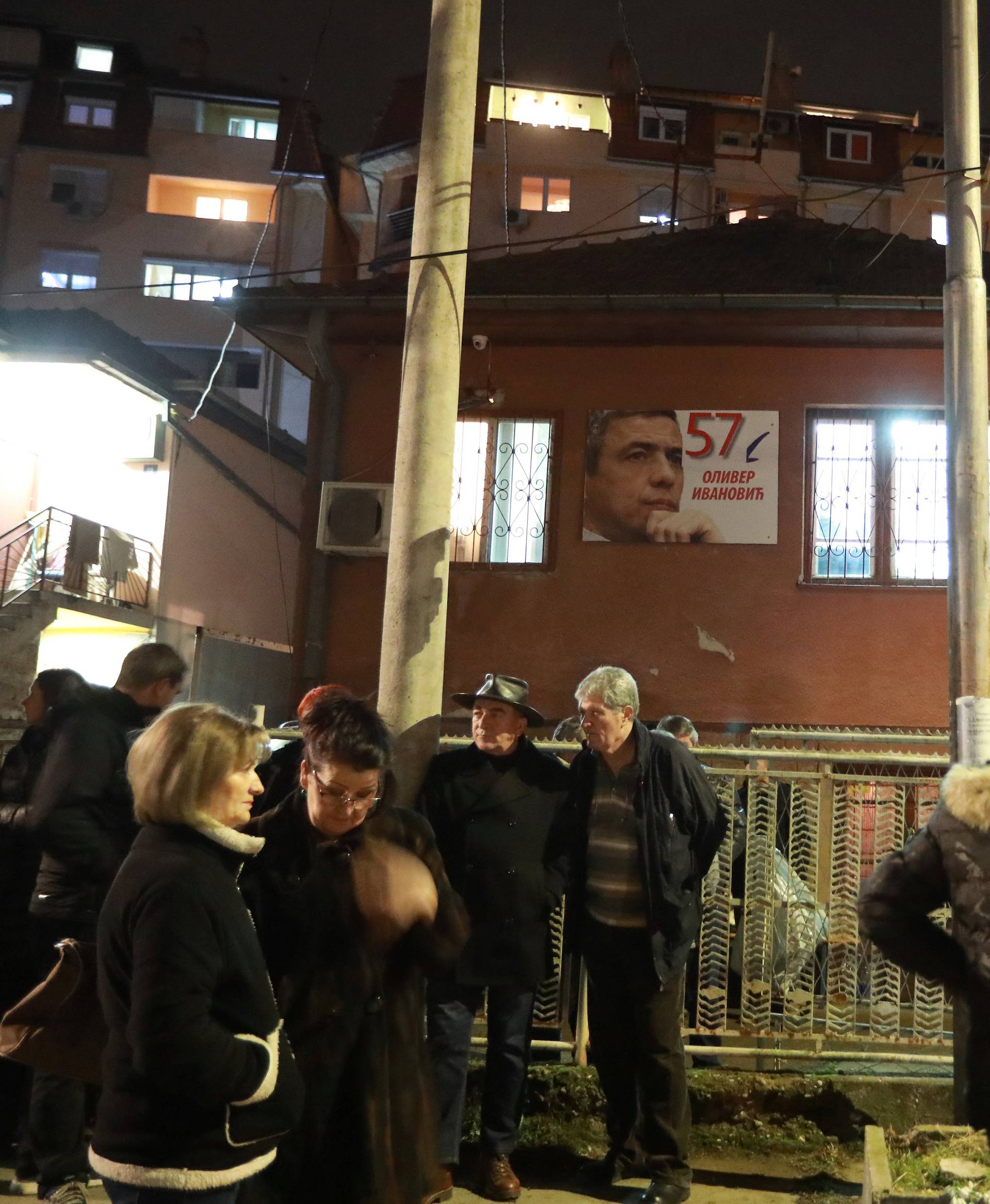 People gather to commemorate Kosovo Serb leader Oliver Ivanovic in front of his house in Kosovska Mitrovica