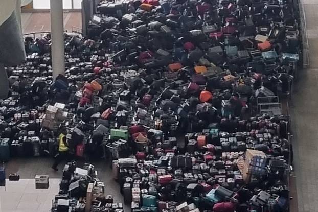 Hundreds Of Suitcases Continue To Mount Up At Heathrow Terminal 2 This Morning