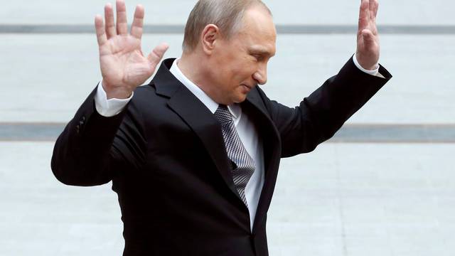 Russian President Vladimir Putin gestures during a meeting with journalists after a live broadcast nationwide call-in in Moscow