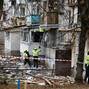 Emergency responders work at the site of a Russian drone strike on an apartment building, in Kyiv