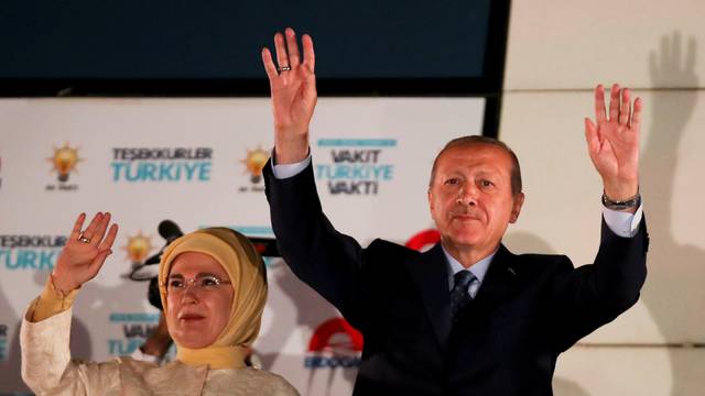 Turkish President Tayyip Erdogan and his wife Emine Erdogan greet supporters gathered in front of the AKP headquarters in Ankara