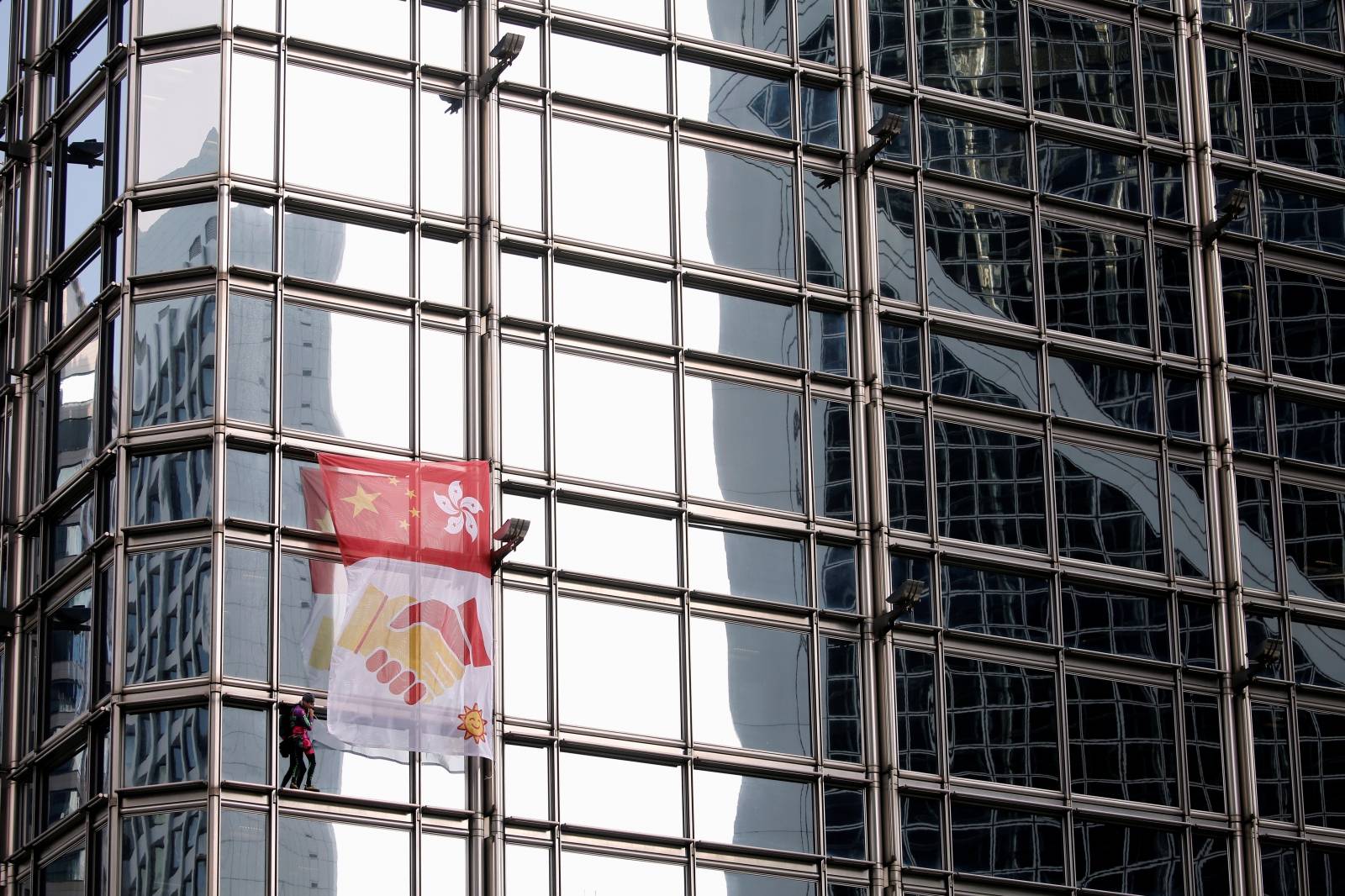 French urban climber Alain Robert climbs the Cheung Kong Center building in Hong Kong