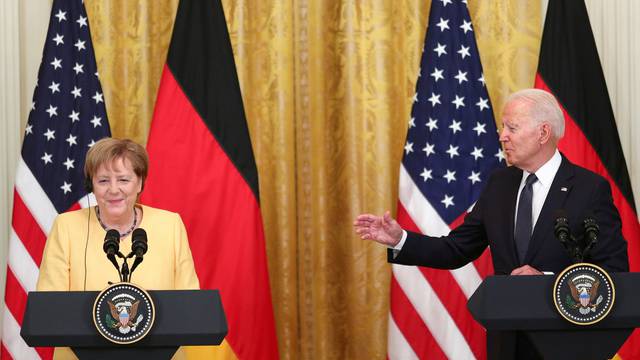 U.S. President Joe Biden and German Chancellor Angela Merkel attend a joint news conference in the East Room at the White House