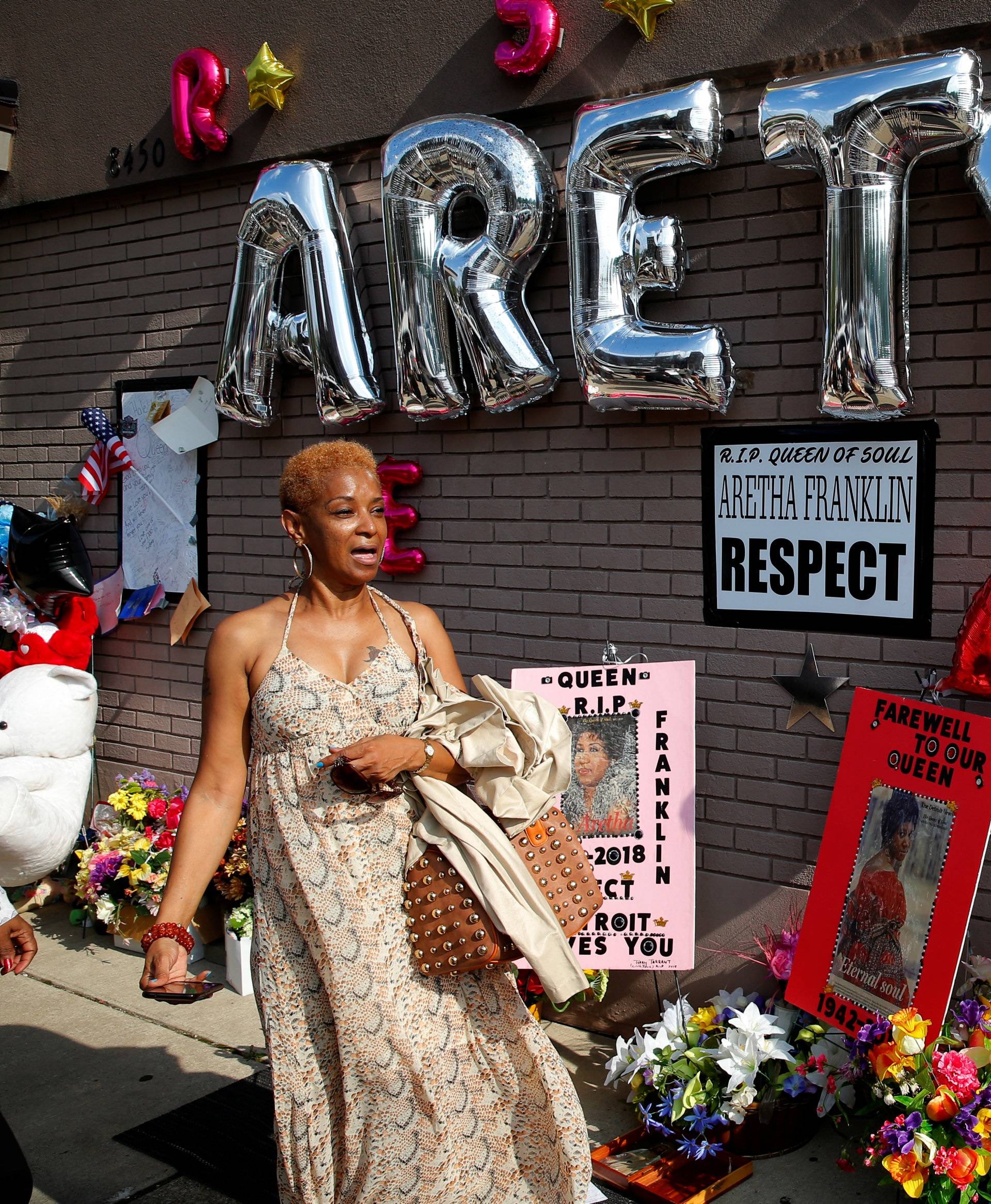 A woman stands by a makeshift memorial outside the New Bethel Baptist Church before a gospel tribute concert to late singer Aretha Franklin at in Detroit